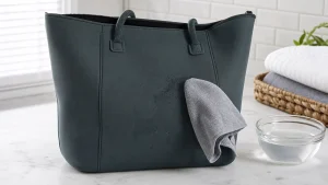 Neoprene tote bag being gently cleaned with a soft cloth