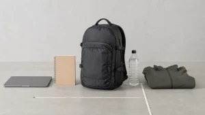 20 liter backpack shown beside a ruler and everyday carry items for scale